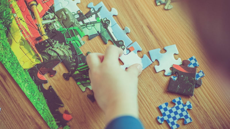 A child playing with puzzle pieces autism concept