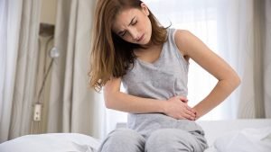 A woman suffering of menstrual cramps