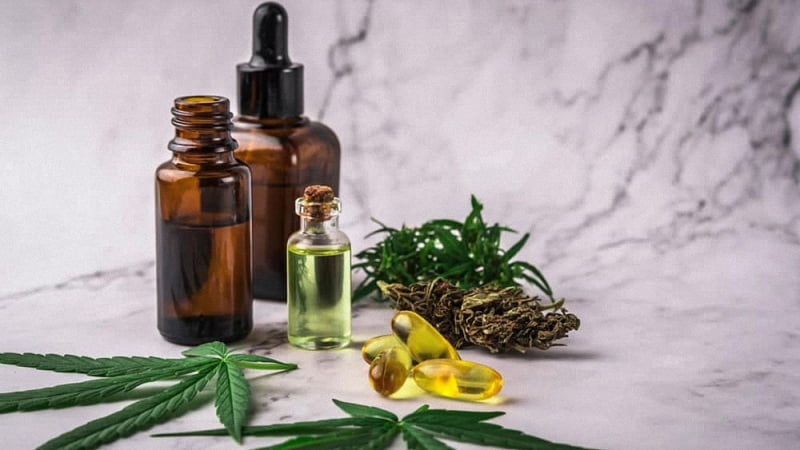 CBD Products with Hemp Leaves in Marble Background