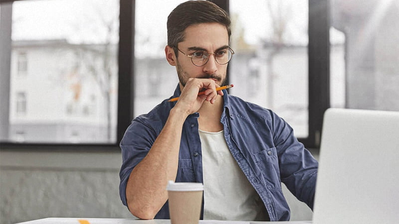 man concentrating with work in his desk