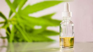 CBD Oil for Trigeminal with Dropper with Hemp Flower Background