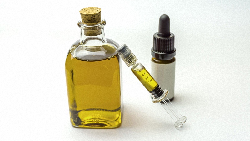 CBD Oil in Bottle and Syringe