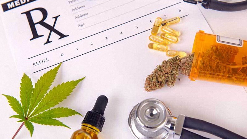 Prescription Pad with CBD Oil Capsules Hemp Leaf and Flower with Stethoscope
