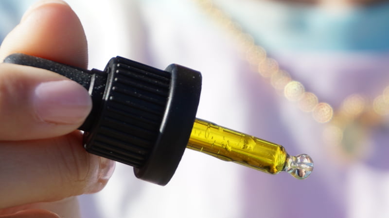 Hand Holding Dropper with CBD Oil